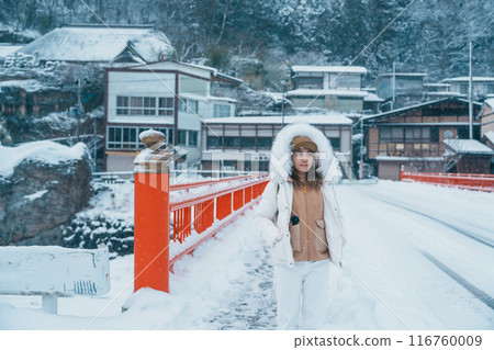 Woman tourist sightseeing Yamadera village with snow in winter, traveler travel Risshakuji temple in Yamagata City, in Yamagata Prefecture, Tohuku, Japan. Landmark for tourists attraction in Japan 116760009