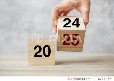 hand flipping block 2024 to 2025 text on table. Resolution, strategy, plan, goal, motivation, reboot, business and New Year holiday concepts hand flipping block 2024 to 2025 text on table. Resolution, strategy, plan, goal, motivation, reboot, business and New Year holiday concepts 116761236