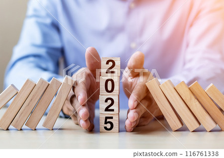 Businessman hand Stopping Falling of 2025 wooden Blocks. Business, Risk Management, Insurance, Resolution, strategy, solution, goal, New Year New You and happy holiday concepts Businessman hand Stopping Falling of 2025 wooden Blocks. Business, Risk Management, Insurance, Resolution, strategy, solution, goal, New Year New You and happy holiday concepts 116761338