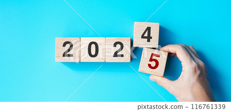 hand holding wooden cube block with 2025 text on blue background. Resolution, plan, review, goal, start and New Year holiday concepts hand holding wooden cube block with 2025 text on blue background. Resolution, plan, review, goal, start and New Year holiday concepts 116761339