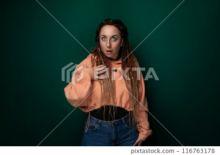 Woman With Dreadlocks Standing in Front of Green Background 116763178