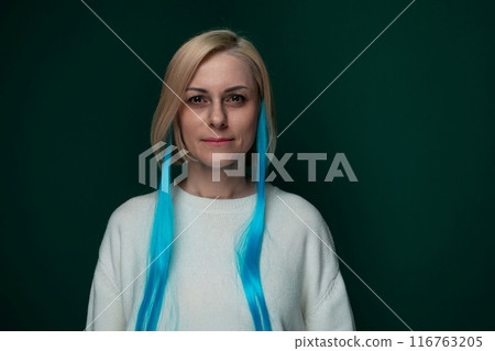 Woman With Long Blue Hair Standing in Front of Green Background Woman With Long Blue Hair Standing in Front of Green Background 116763205