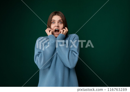 Woman in Blue Sweater Making Surprised Face Woman in Blue Sweater Making Surprised Face 116763289