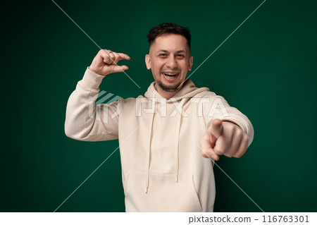 Man in White Hoodie Pointing at Camera 116763301