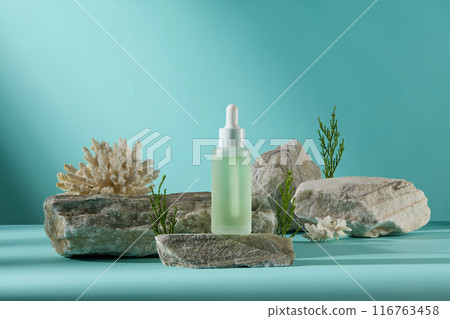 Mockup for cosmetic advertising was taken under the sea from frontal view with empty label serum bottle displayed on the rock, surrounded by coral, stone and seaweed Mockup for cosmetic advertising was taken under the sea from frontal view with empty label serum bottle displayed on the rock, surrounded by coral, stone and seaweed 116763458