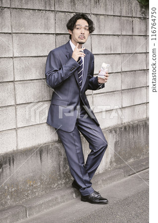 Man smoking outdoors Man smoking outdoors 116764750