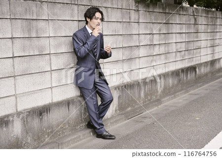 Man smoking outdoors 116764756