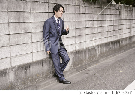Man smoking outdoors Man smoking outdoors 116764757
