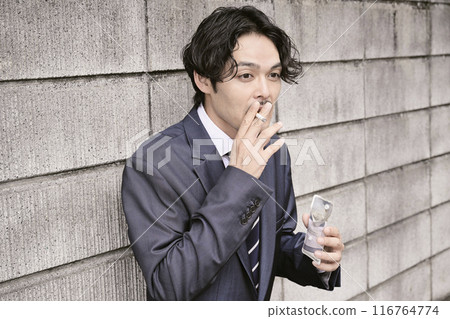 Man smoking outdoors 116764774