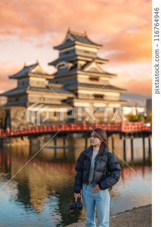Woman tourist Visiting in Matsumoto, happy Traveler sightseeing Matsumoto Castle or Crow castle. Landmark and popular for tourists attraction in Matsumoto, Nagano, Japan. Travel and Vacation concept Woman tourist Visiting in Matsumoto, happy Traveler sightseeing Matsumoto Castle or Crow castle. Landmark and popular for tourists attraction in Matsumoto, Nagano, Japan. Travel and Vacation concept 116764946