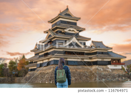Woman tourist Visiting in Matsumoto, happy Traveler sightseeing Matsumoto Castle or Crow castle. Landmark and popular for tourists attraction in Matsumoto, Nagano, Japan. Travel and Vacation concept Woman tourist Visiting in Matsumoto, happy Traveler sightseeing Matsumoto Castle or Crow castle. Landmark and popular for tourists attraction in Matsumoto, Nagano, Japan. Travel and Vacation concept 116764971
