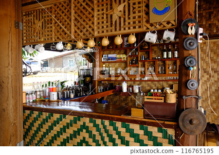 Counter cafe Designed with woven bamboo and barista making coffee for customers in countryside of Thailand Counter cafe Designed with woven bamboo and barista making coffee for customers in countryside of Thailand 116765195