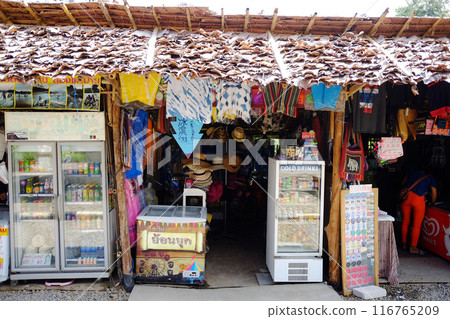 Local Souvenir shop in the old wooden house on street market at countryside. Local Clothing store in Thailand 116765209