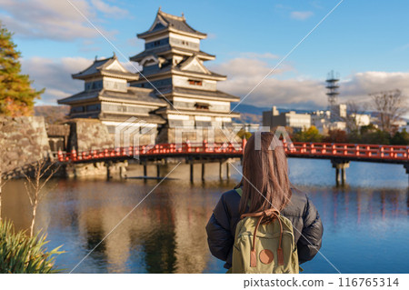 Woman tourist Visiting in Matsumoto, happy Traveler sightseeing Matsumoto Castle or Crow castle. Landmark and popular for tourists attraction in Matsumoto, Nagano, Japan. Travel and Vacation concept Woman tourist Visiting in Matsumoto, happy Traveler sightseeing Matsumoto Castle or Crow castle. Landmark and popular for tourists attraction in Matsumoto, Nagano, Japan. Travel and Vacation concept 116765314