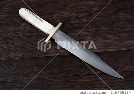 Old west bowie knife on wooden deck Old west bowie knife on wooden deck 116766124