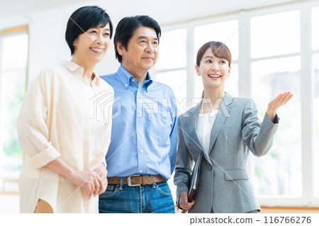 A middle-aged couple consulting with a consultant at home 116766276