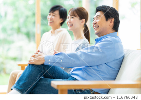 A family relaxing in the living room 116766348