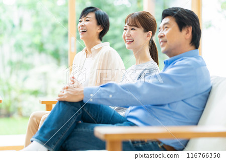 A family relaxing in the living room 116766350