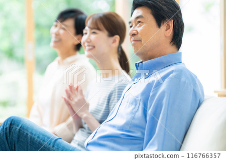 A family relaxing in the living room 116766357
