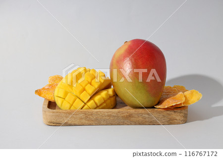 Ripe juicy mango on a wooden board 116767172