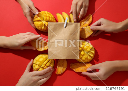 A paper bag with fresh and dried mangoes A paper bag with fresh and dried mangoes 116767191