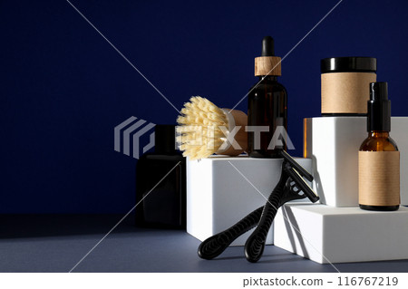 Shaving tools and bottles of men's cosmetics on dark blue background, space for text Shaving tools and bottles of men's cosmetics on dark blue background, space for text 116767219