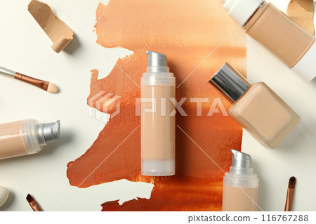 Bottles with foundation and brushes on white background, top view 116767288