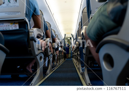 Airplane background selective focus. Blur. The passage between the seats inside the aircraft cabin. Passengers are ready to fly. 116767511