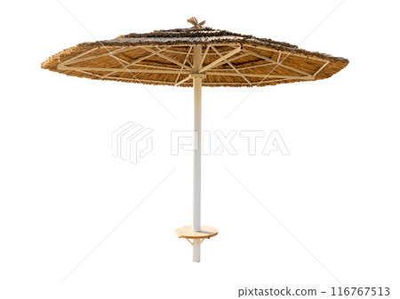 Large beach umbrella made of straw isolated on white background. Sun protection in a resort by the sea or ocean. Tropics 116767513