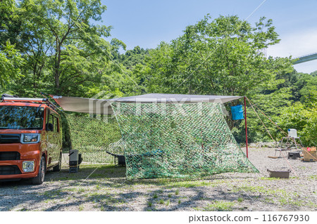 [Auto camping site: Tarp set up in the woods, hanging net] 116767930
