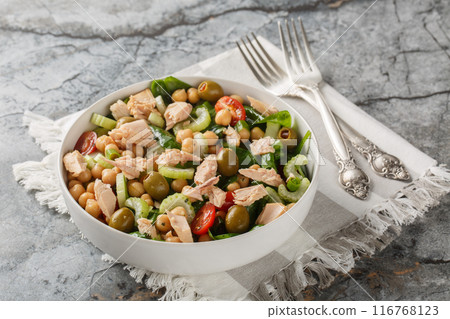 Delicious chickpea tuna salad with healthy ingredients like fresh vegetables and herbs close-up in a bowl. Horizontal 116768123