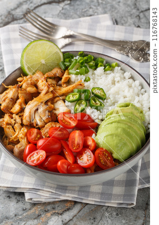 Chicken Carnitas bowl or burrito bowl with rice, tomatoes, jalapeno pepper and avocado close-up. Vertical Chicken Carnitas bowl or burrito bowl with rice, tomatoes, jalapeno pepper and avocado close-up. Vertical 116768143