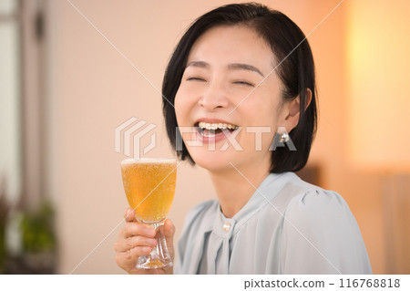 A middle-aged woman drinking beer with relish A middle-aged woman drinking beer with relish 116768818