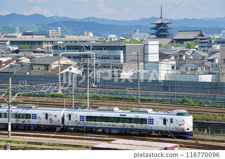 The Haruka Express train runs alongside Toji Temple in Kyoto 116770096