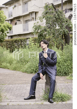 Man sitting outdoors 116770215