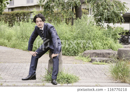Man sitting outdoors Man sitting outdoors 116770218