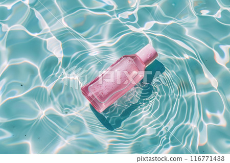 Pink bottle floating in clear water with ripples and pastel reflections 116771488