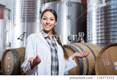 Woman sommelier is tasting wine at wine factory Woman sommelier is tasting wine at wine factory 116771533
