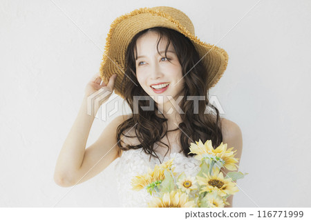 Woman in wedding dress holding sunflowers Woman in wedding dress holding sunflowers 116771999