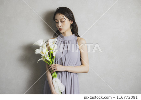 Woman holding a bouquet of calla lilies 116772081