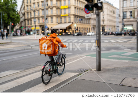 Vienna, Austria, August 21, 2022. A rider from Lieferando, home delivery company for food and drink. It is easy to notice them Vienna, Austria, August 21, 2022. A rider from Lieferando, home delivery company for food and drink. It is easy to notice them 116772706