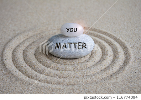 You matter text engraved on Zen stone on sand with light shining. Motivational and inspirational concept 116774094
