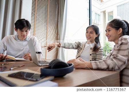 Group of Diverse Students Collaboration on a Project in a Modern Study Space with Laptops and Notebooks 116775367