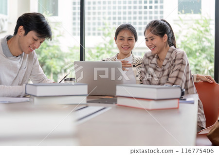 Group of Happy Students Studying Together with Laptops and Books in a Bright Modern Classroom Group of Happy Students Studying Together with Laptops and Books in a Bright Modern Classroom 116775406