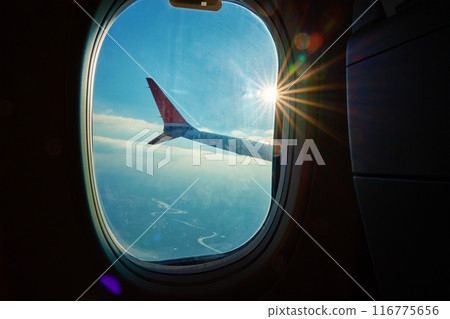Airplane Wing View with Sunrise through Window 116775656