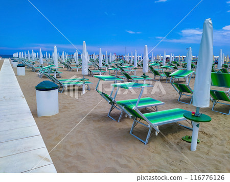 the sunbeds and parasols on the beach 116776126