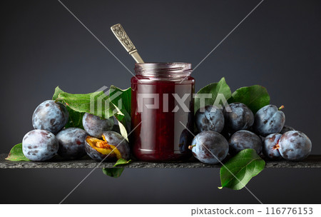 Plum jam and fresh berries on a black background. 116776153