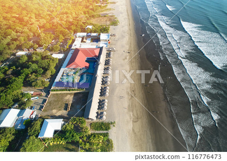 Tropical hotel with pool on clean beach 116776473