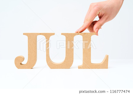 Wooden alphabet blocks arranged with the letter "JUL" 116777474