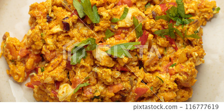 Close up of akuri indian style scrambled eggs with spices and herbs top view 116777619